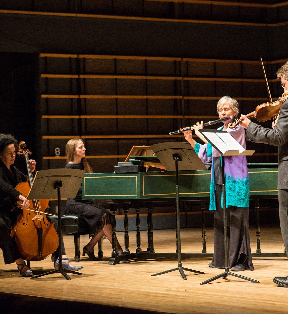 Concert at Oscar Peterson Theatre Quartet performing on Oscar Peterson stage: harpischord or period piano, cello, baroque flute and violin
