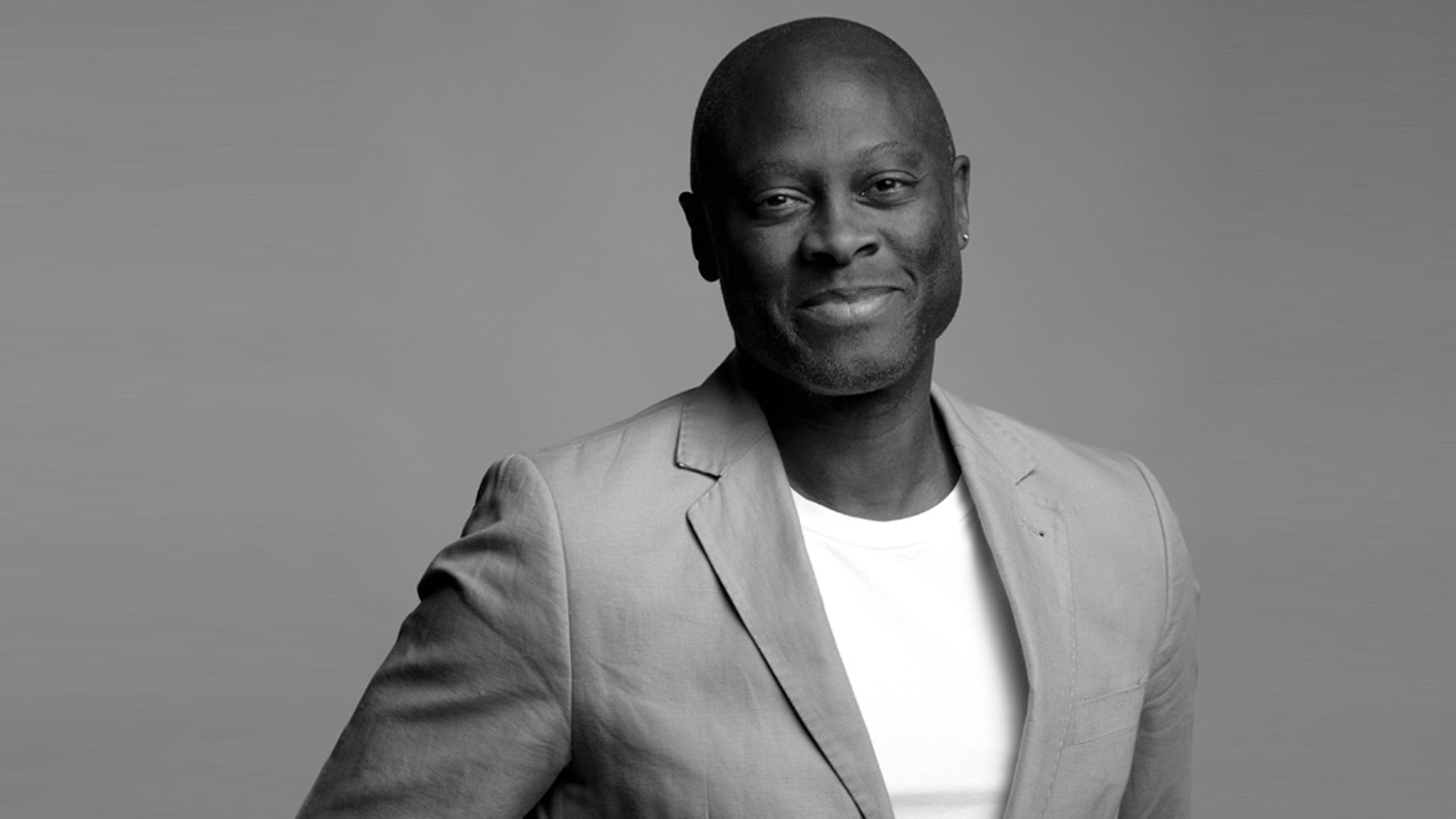 Sabaa Quao In this black and white photo, Sabaa wears a white T-shirt under a grey jacket.